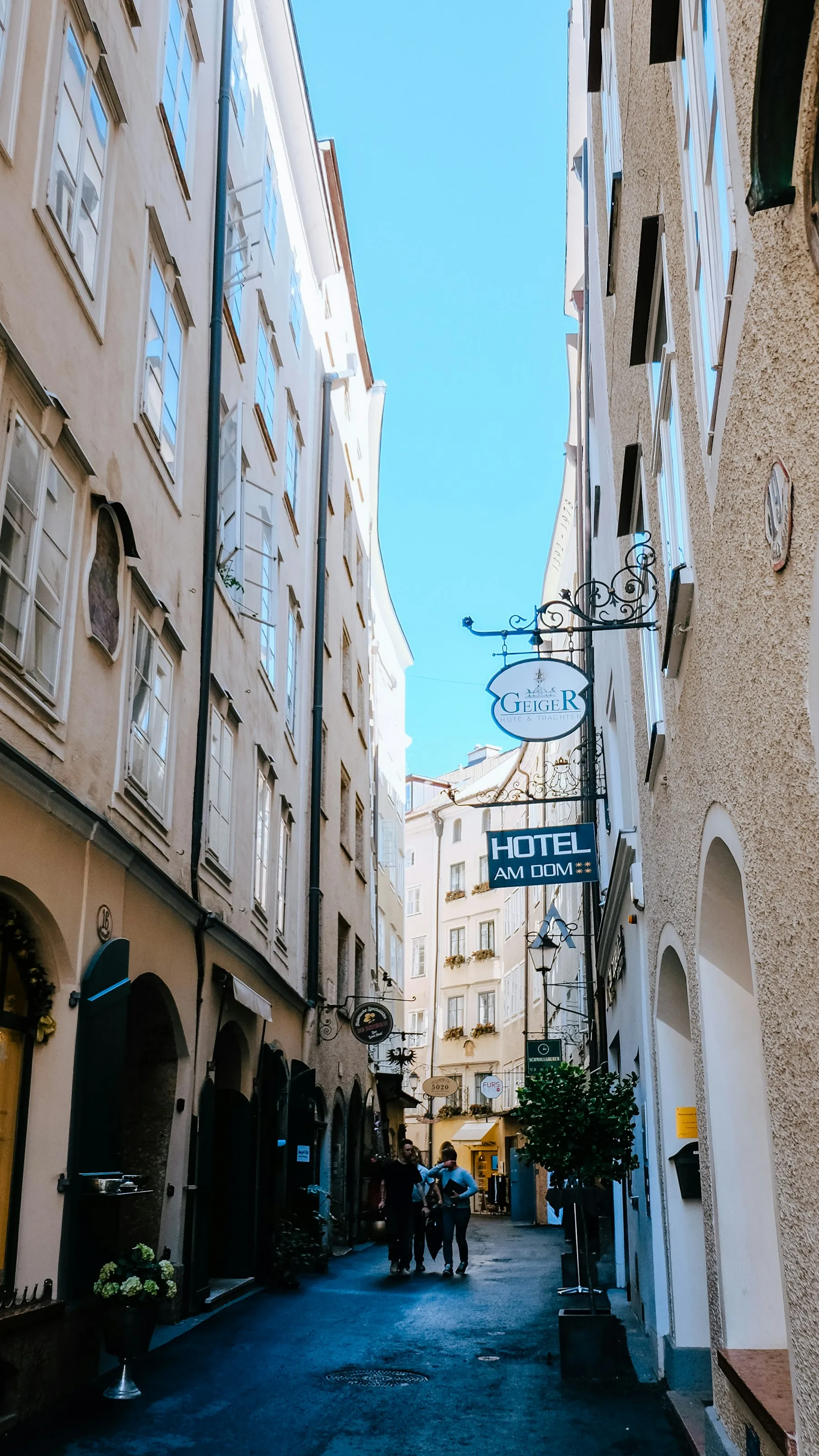 Enge Gasse der Salzburger Altstadt mit schmiedeeisernen Wirtshausschildern